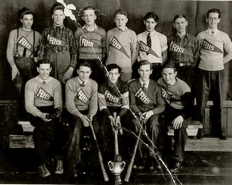 My Dad Lorne (bottom left) and my Uncle Ray (top right) with the rest of the baseball team from Rossland High School in Rossland BC Canada. I don't know what the trophy was for, but I do love the pinned on pennants they are all wearing. This would be about 1935. 
