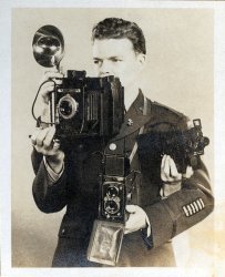 WWII Signal Corps photographer Lt. Robert F. Tacey.  An example of his photography can be seen on this blog.