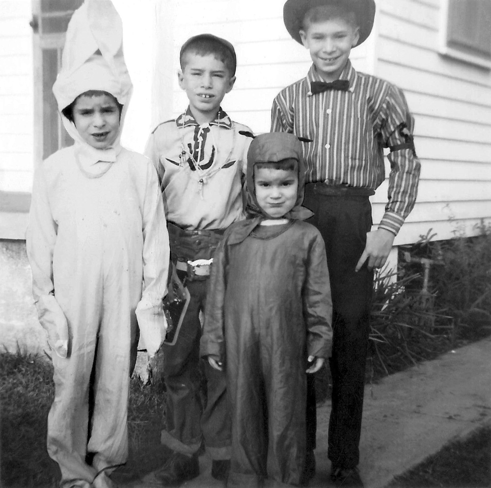 Mardi Gras Day Feb 14, 1961. The holidays are over, the nation settles into a deep freeze, except in New Orleans, where all attention turns to Mardi Gras. For all the people you see costumed on Mardi Gras, it begins at home. I am in the bear costume, at 3 years old. My older brothers are a cowboy, and a circus master riverboat gambler, and my sister is a bunny rabbit. After the family picture, we would head to the parades. It must not have been a very cold winter that season, as the exposed water pipe is not wrapped! If we had a forecast of a "hard" freeze (mid 20's or below), Dad would wrap it for the rest of the season. View full size.