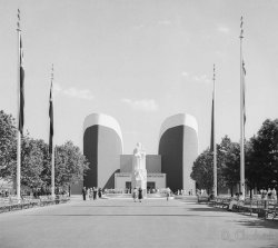 One of the Transportation Zone’s exhibits at the 1939 New York World’s Fair. The twin ship prows were each 80 ft high.  The  architects of the building were Ely Jacques Kahn, William Muschenheim and Morrison J. Brounn.  Scanned from the original 2.25x2.25 inch negative. View full size.
Worthy of Bruce McCallWhose high-concept satirical drawings of "wonders that never were" were inspired by real life wonders like this. Thanks for sharing!
(ShorpyBlog, Member Gallery)