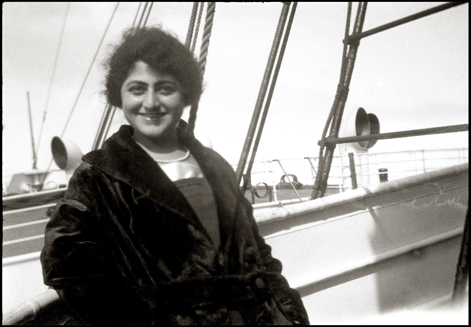 Mary Jorjorian (1900 - 1979), sailing aboard the S.S. Mohawk from Jacksonville, Florida, back home to New York City, April 4, 1921. The photo was taken on Mary's medium-format Brownie camera by an unknown shipmate. Mary, age 20, had been living in Jacksonville for five months to assist her older sister deliver and care for her second child. Here she is returning alone. As buoyant as she appears, Mary is at this moment quite lovesick. She fell in love in Jacksonville with a family friend, Daniel Eliseian, who then departed for Buenos Aires.

Mary was an Armenian, born in Sivas, Turkey, but arrived in America with her family as a baby in 1901. Her family was poor but cultured. Mary attended Wadleigh High School, New York's first public secondary school for girls. She was a self-described "progressive modern woman." She wanted to attend Hunter College, to become a teacher or social worker, but family finances kept her sidelined. She remained an avid reader and independent learner, though, throughout her life. While in Jacksonville, she was reading Margaret Sanger's "Women and the New Race." She was also a big fan of movie pictures, catching multiple photoplays each week, especially those which featured strong or dynamic women.

She played the piano with some skill, and worked out a duet with Daniel (who was an even better violinist) of the piece, "Meditation" from Massenet's opera, "Thais." Mary started up a correspondence with Daniel in Buenos Aires, where he stayed for three long years, becoming a master tailor. But in June 1924, he returned. They married and settled in Oakland, California, where their grandchildren still live. Mary and Daniel are my wife's maternal grandparents. This photo is from Mary's box of negatives. View full size.