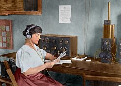 This colorized image shows Mary Texanna Loomis, the first woman in the U.S. to run a radio school, operating her radio station in 1921. Her school, the Loomis Radio College, operated in Washington, D.C., in the 1920's and 1930's.  She is seated at an early receiver that uses a panel mounted crystal detector.  The knife switches to the right are probably antenna selectors.  Next to that is an antenna tuner called a "loose coupler", which is connected to a tube receiver out of view on the right.  
I optimized the image in Photoshop and colorized it using AKVIS Coloriage software.  The original black and white photo is in the Library of Congress collection and can be seen at http://www.loc.gov/pictures/item/97504677/. View full size.
(Colorized Photos)