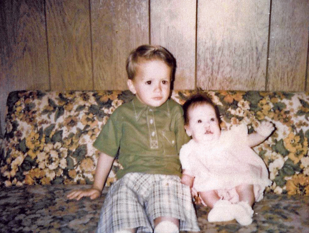 My sister and me in Spring, 1970. Fountain, Colorado. I am four years old and sure, while I was styling in the early 70s style, I still cringe at the short pants and that green shirt - almost as much as I cringe about the couch we are sitting on and the wood paneling of my grandmother's home. 

My mother took the image using her Kodak Instamatic 104 using Kodak 126 film she dropped off at a Fotomat on US 85/87 in Security. I am sure a flashcube was needed - it was inside, although I suppose sunlight could have penetrated Grandma's heavy curtains. 

My sister was born with a double cleft lip and palate. Her first of 40 corrective surgeries will come within a year. View full size.