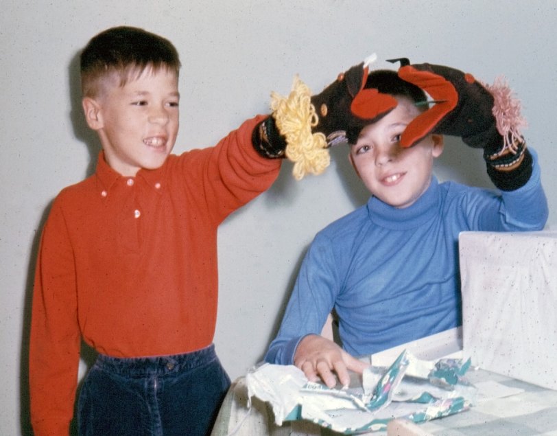 Playing with some sock puppets my mom made.  Mid-60s, Ohio. View full size.
