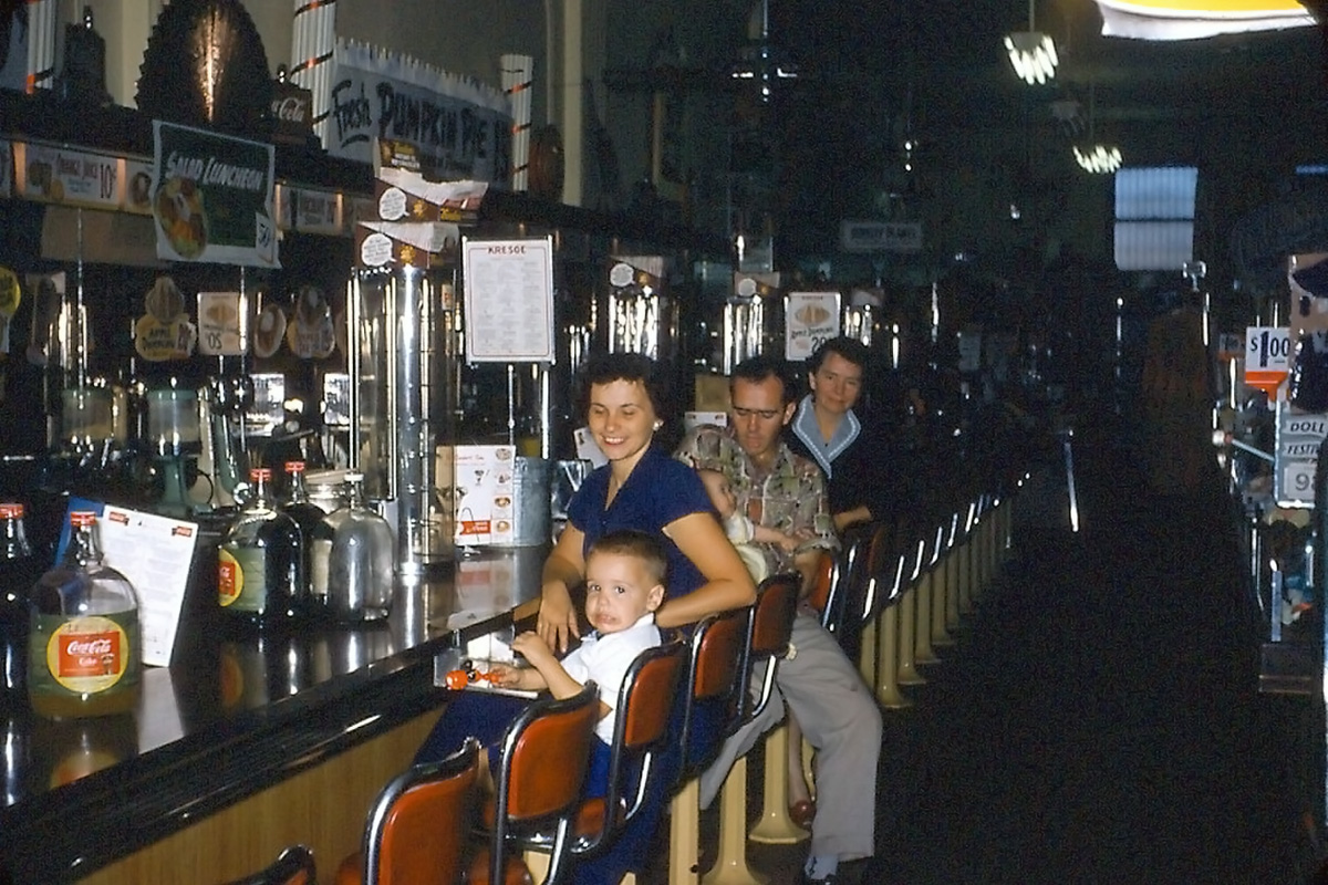 This is the interior of an SS Kresge Dime Store in Park Forest, Illinois. I am up front, then mother, brother George, Dad, and his mother. Granddad is taking the picture, a 35mm Kodachrome slide. There sure is a lot of counter clutter. View full size.