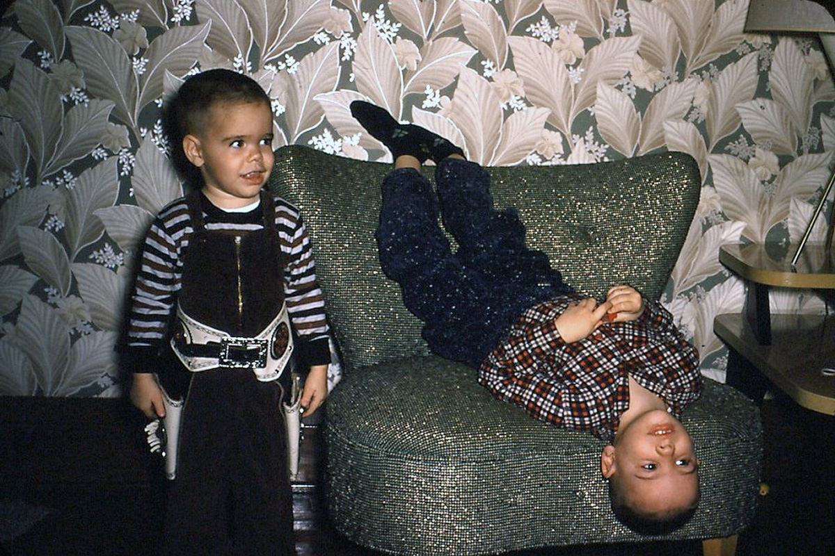 My brother George and I did not always see things from the same perspective. Nevertheless, we have remained good friends and genuinely liked each other over the years. In this photo he, age 3, is wearing a fancy two-gun cowboy belt. This 35mm Kodachrome slide was taken in Clinton, Iowa, in a two-story house on 3rd Street where our family lived on the lower floor. Exciting wall paper! View full size.