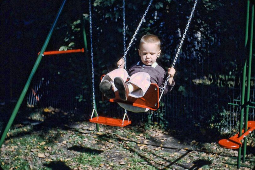 I was dressed nicely for this activity. We must have had important visitors. This was in Clinton, Iowa, 1956 or 1957. I remember the red and green swing set and the fencing material seen near the teeter-totter, as being from that back yard. Another of many 35mm Kodachromes. View full size.

