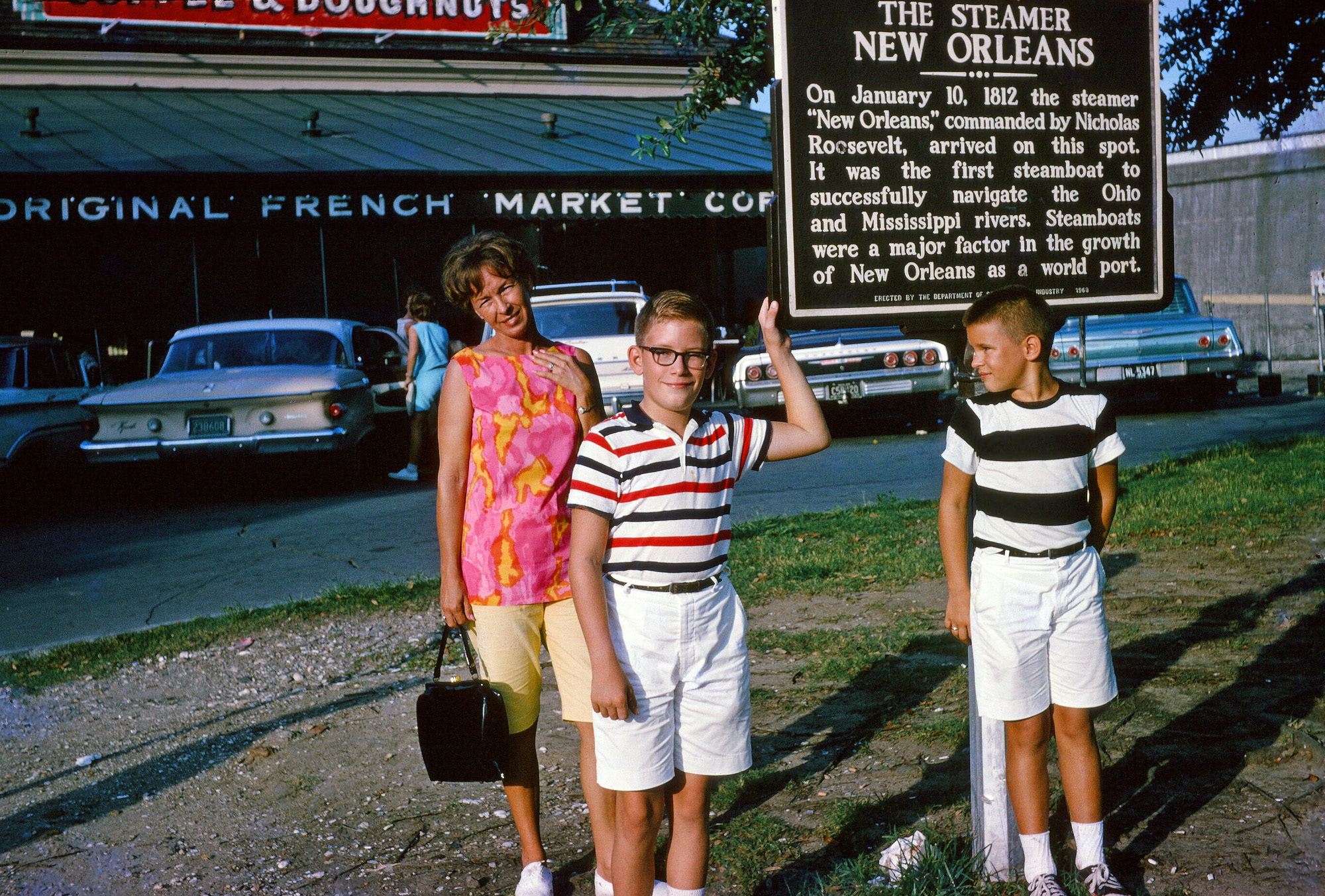 Here are my mom, me (wearing the hated glasses) and my brother Jeffrey again; this time in front of the Café Du Monde in New Orleans; probably taken in 1964. We'd drive over from Houma, where we then lived, and spend the weekends. The New Orleans farmer's market was a fun place to visit in those days; we'd go there after a trip to the Audubon Park Zoo. Point me toward the beignets, please!

After having our fill of powdery donuts and chicory coffee, we'd wander through the French Quarter until evening, then we'd have dinner in an Italian place called, I believe, Madame Turchi's or Turci's. It had the best spaghetti and meatballs I've ever had, before or since. The lady who owned it evidently had been an opera singer at one time long before and she and my mom were great friends. Wonderful days! View full size.


