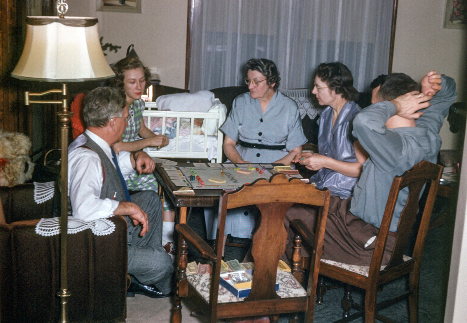 Bert and Iva's daughter Helen is home to Wausau, Wisconsin, from California with the new baby. While Baby sleeps, the grandparents and parents play a lively game of Monopoly. Kodachrome from the Bert's Slides Collection. View full size.