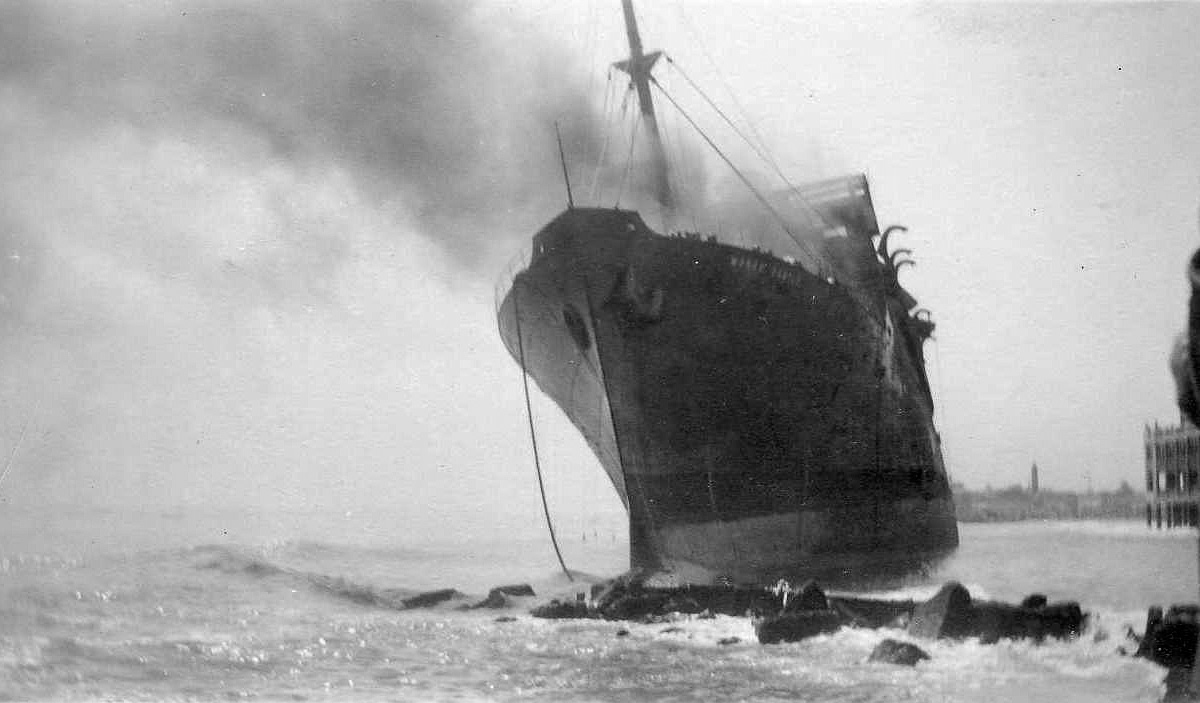 The passenger liner Morro Castle caught fire September 8, 1934 and was abandoned at sea. Of 549 passengers and crew aboard, 135 were lost. Shortly afterward she drifted ashore at Asbury Park, New Jersey and burned for two days. My Aunt Vi probably took this photo. The wreck was a major attraction while it was there. View full size.