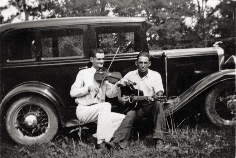 Found in my wife's box of family photos. No living relative has any idea who they are. Both sides of her family are from Texas. The fiddler appears to be blind. I have a second photo of the fiddler with a different guitarist, but Shorpy only allows one photo per upload.
