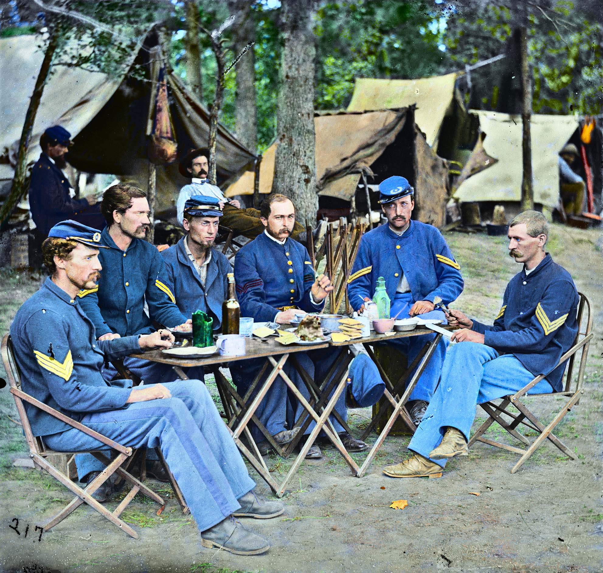NCOs of Company D, 93rd Infantry, New York. Photograph from the main eastern theater of war, Meade in Virginia, August-November 1863.

Colorized with GIMP software. I never noticed the leaf or little blades of grass until I had to colorize them. One gentleman (second from right) has a cut on his finger.  Also, I made everyone's suit is a different color blue. Hope you enjoy.