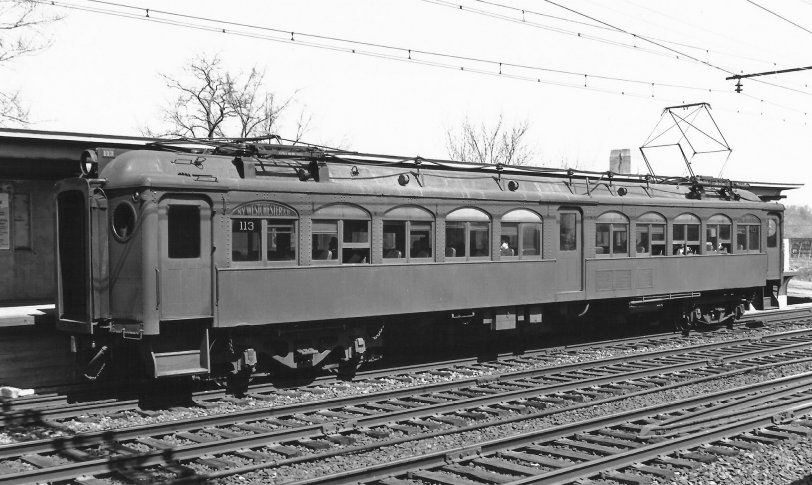 Pictured is a multiple unit electric passenger car of the New York, Westchester and Boston Railway at the Baychester Avenue Station, Bronx New York in May of 1937. “The Westchester” as it was known locally was a rapid transit system that linked the Bronx with White Plains to the north of New York City and subsequently Port Chester to the east. At the time of the railway's construction in 1912, the NYW &amp; B was one of the most advanced systems in the world with state of the art equipment, signaling, overhead power supply and exquisite stations of masonry and concrete in both the Italian Renaissance and Mission architectural styles. The NYW &amp; B ceased operation in late 1937, a victim of The Great Depression, the emerging popularity of the automobile and mismanagement of its parent company, the New Haven Railroad. View full size.
