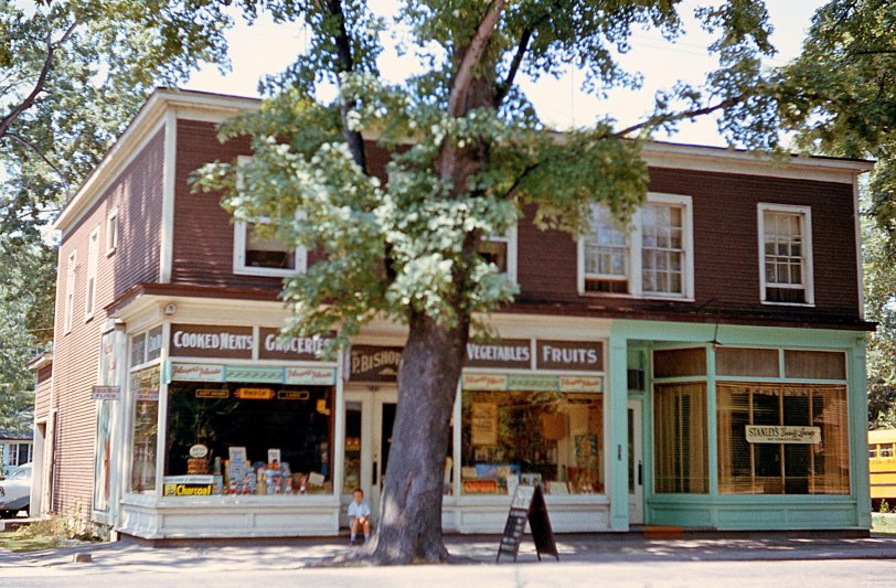 This is a shot of my grandfather's grocery store in Niagara-on-the Lake, Ontario, which he operated from the time he constructed the building in 1910/1911, until 1962, when he was well into his 80s. He lived in the apartment at the upper right of the building and I fondly recall many visits. Note the distinctly Canadian signage (Robin Hood flour, Player's Cigarettes) and in the front window can be seen his famous banana tree with fruit, covered in a St. Catharines Standard newspaper article of the era. That would be me, as an 8-year-old, sitting on the front step. View full size.
