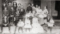 This is a portrait of our extended family circa 1900 at Niagara-on-the-Lake, Canada. They operated the Union Jack Canning Company which during that period canned, under the Union Jack brand, fruits and vegetables from the Niagara Peninsula such as peaches, pears, cherries, tomatoes and green beans. (Framed period labels of the cannery adorn our kitchen wall.) I remember my dad and his cousin Elizabeth from Niagara finding and opening a can of tomatoes from the cannery in the late sixties - it looked O.K - but nobody dared to try it.
Second from left in the second row is my paternal grandfather, who ran a grocery store in Niagara from the early 1910s to the 1960s - seen here with me as a kid sitting on the front store steps in the late 1950s. Next to him, the child, I believe, is the future first head of Regional Niagara government in the late-1960s. View full size.
(ShorpyBlog, Member Gallery)