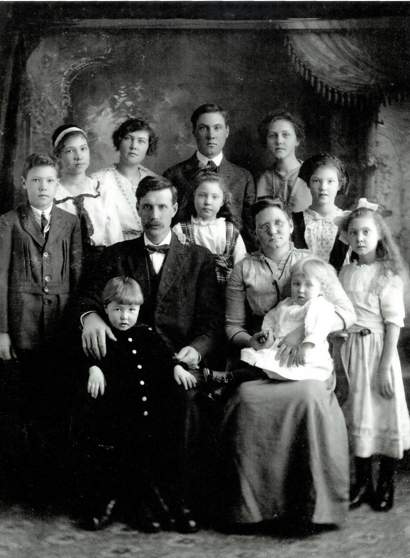 Charles and Phoebe Nord and ten of their children in Balaton, Minnesota, about 1914.  My great-grandmother Florence is standing, second from left (with the white ribbon in her hair).  Another boy was born three years later. View full size.
