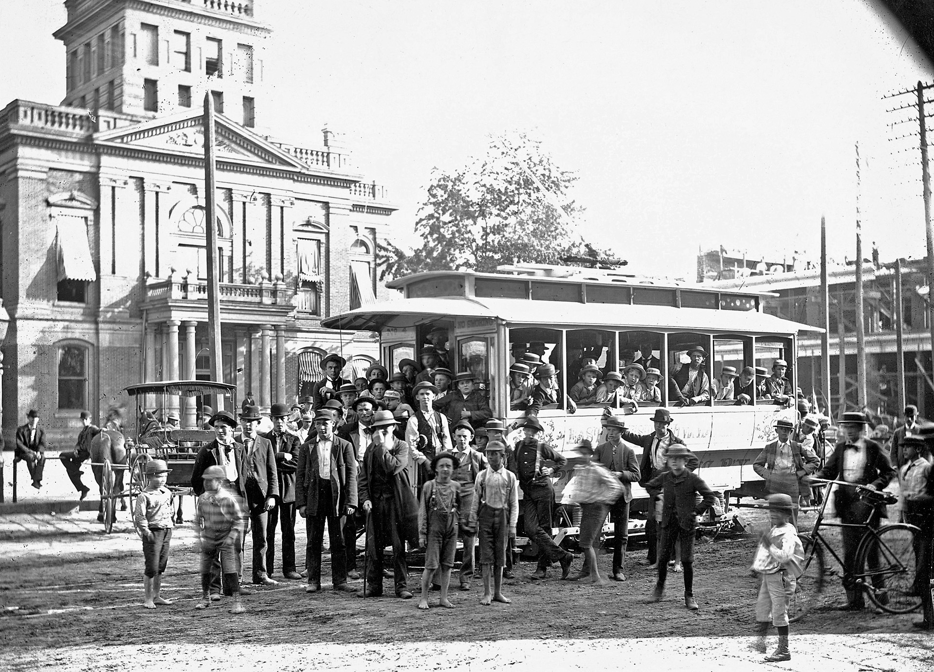 Norwalk, Ohio, somewhere between 1885 and 1905. What appears to be a new trolley service in front of the county courthouse. The side of the trolley reads: East Chestnut via Water St. From my grandfather's collection. View full size.