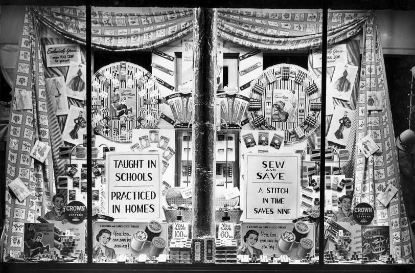 One of my great uncle's F.W. Woolworth displays from the 1930's, probably in Findlay Ohio.  He and my great aunt would work into the night building these displays and then take pictures of the final product.  This one shows the benefits of sewing it yourself.  He even covered the pole in aluminum foil. View full size.
[This appears to be 1952, the year National Sew and Save Week was held Feb. 23 to March 1; that's also consistent with the early-50s fashion styles in the illustrations. -tterrace]
