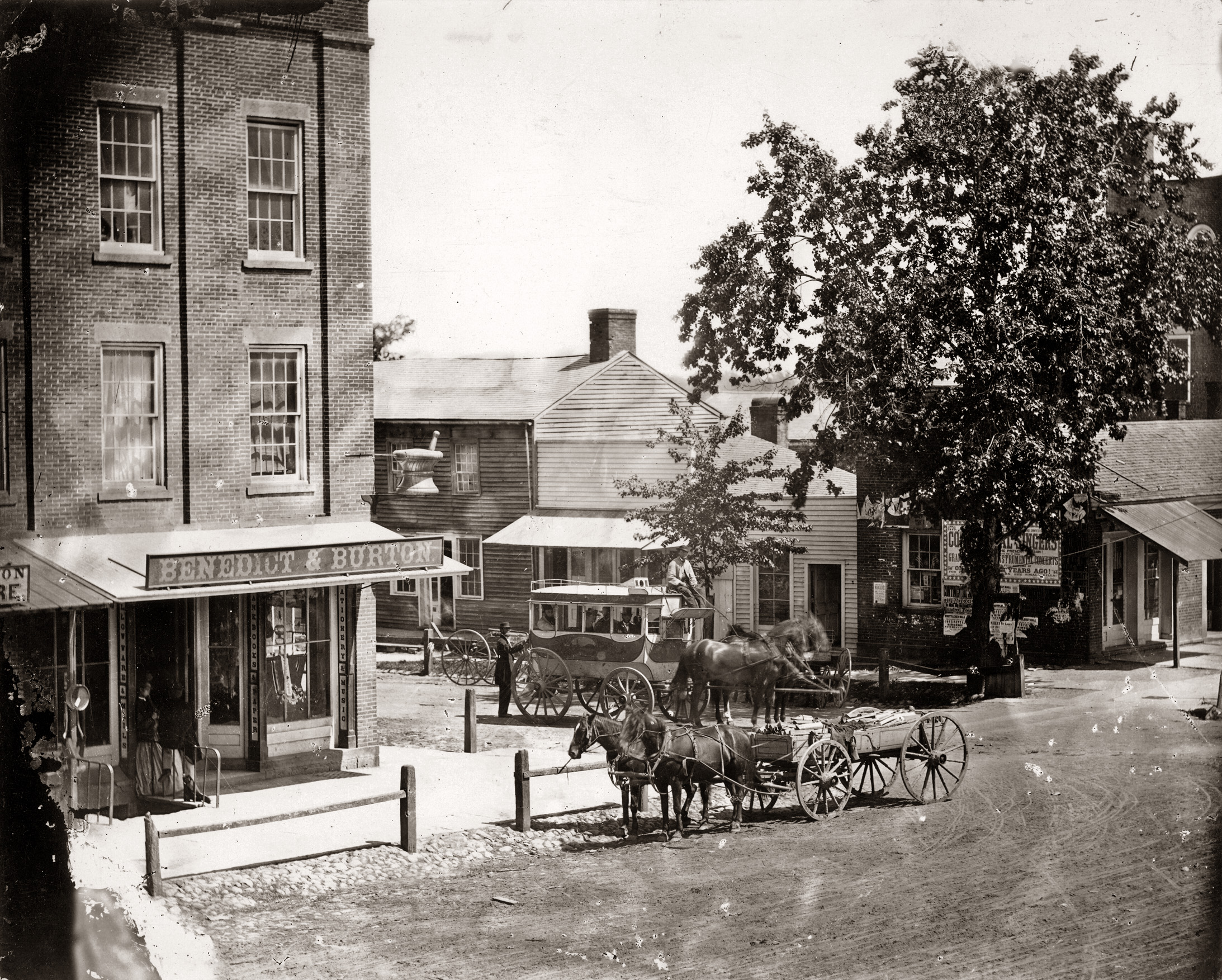 A corner on Main Street in Norwalk Ohio in 1876. The apothecary of Benedict and Burton can be seen, as well as an arriving stagecoach with several Abraham Lincoln look-alikes.  From my grandfather's personal collection. View full size.