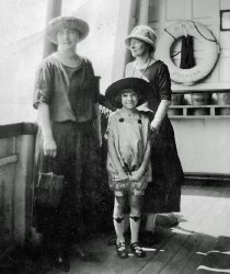 Before the Ambassador Bridge and the Detroit/Windsor tunnel were built in 1929, ferry boats ran between these two international cities on the Detroit River. Here's my grandmother, her sister, and my aunt Dana on the D&amp;W ferry boat "Promise" in 1924.  Note the name on the life preserver. View full size.
Unique outfit!The little girl's outfit is very cute and quite unique, I think! I can't imagine putting satin on a little girl, except for church or something fairly formal wear. I'll bet she was asked to be very careful!
(ShorpyBlog, Member Gallery)