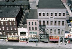 The building on the right is the former Odd Fellows Temple, built in 1874 at the northeast corner of Randolph and Monroe Streets in Detroit, Michigan.  Today it houses a Buffalo Wild Wings restaurant.
This is a scan of a Kodachrome transparency that was taken in July 1968 from the roof of Crowley's Department Store, which was demolished in 1978. View full size.
(ShorpyBlog, Member Gallery)