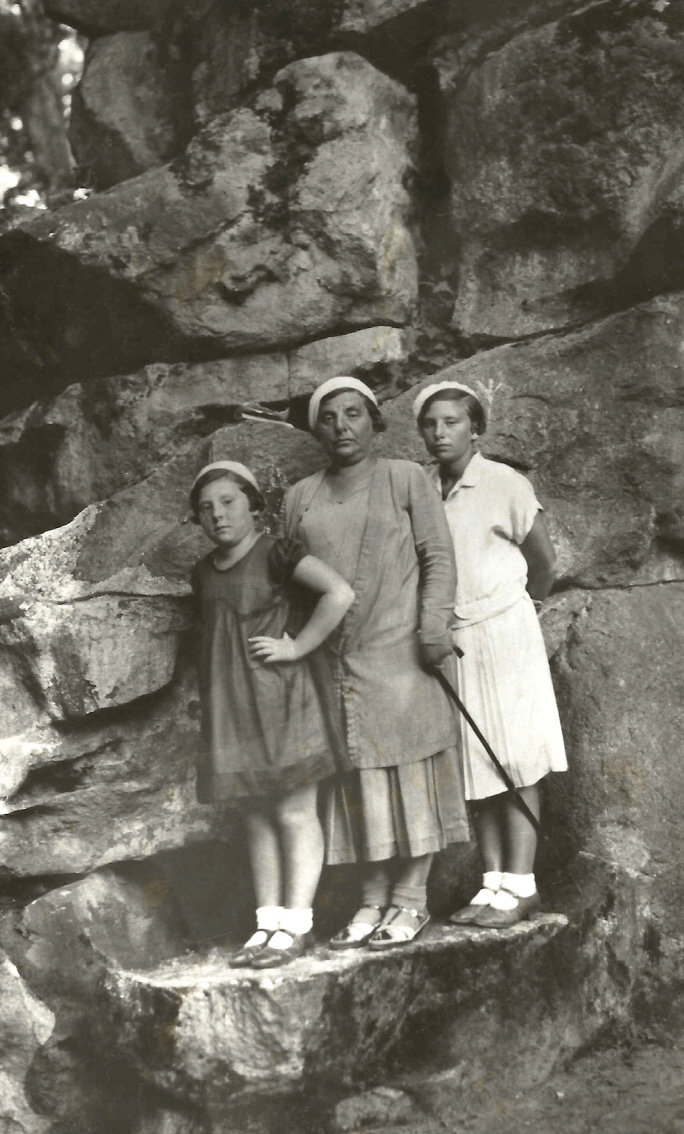 Three relatives of my grandmother pose tourist style, quite literally, on the rocks. Is the center woman with the cane the grandmother of the girls, or their mother? I have nobody to ask. But I know by context and clothing that the date is the late 1920s or early 1930s. The location is probably Lithuania. The lady with the cane is one of the Beach People. And, of course, nobody is smiling. 

