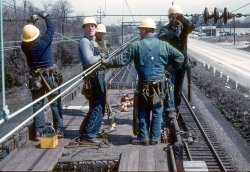 As a management trainee on the Pennsylvania Railroad in the late 1950s I was assigned to the overhead catenary inspection car.  I always carried a small Retina III in my pocket, so when I told the crew I wanted to take their picture they started hamming it up. No, the wire isn't hot.  The pantograph yonder serves as a direct ground to the rail and the inspection car was propelled by diesel. The Supervisor is the fellow farthest from the camera. Those brown porcelain insulators made for some fine target practice for the local riflemen.  35mm Kodachrome by William D. Volkmer Daylesford, PA April 8, 1960. View full size.
Thank You, Mr. Volkmer.These views of workaday life on the late great Pennsylvania Railroad are priceless. I'll never forget the first time I rode behind — a pair no less — of GG1s hauling the Broadway out of Harrisburg, back in the early Amtrak days. Once you become aware of their grace and power, you were hooked for life.
Do those fellows have their C.T. 290s in their pockets? I see one of the first requirements for the job was to bend up a copper wire to string your sockets on.
I grew up in Cleveland many years too late to witness the P1a motors before they were sent off to Grand Central. I used to walk the Cleveland Union Terminal right-of-way often and on one occasion I found a copper "trolley clip" that had lain in the ballast for over 30 years. It is one of my prized possessions.
Again, thank you for sharing these wonderful photos.
(ShorpyBlog, Member Gallery)