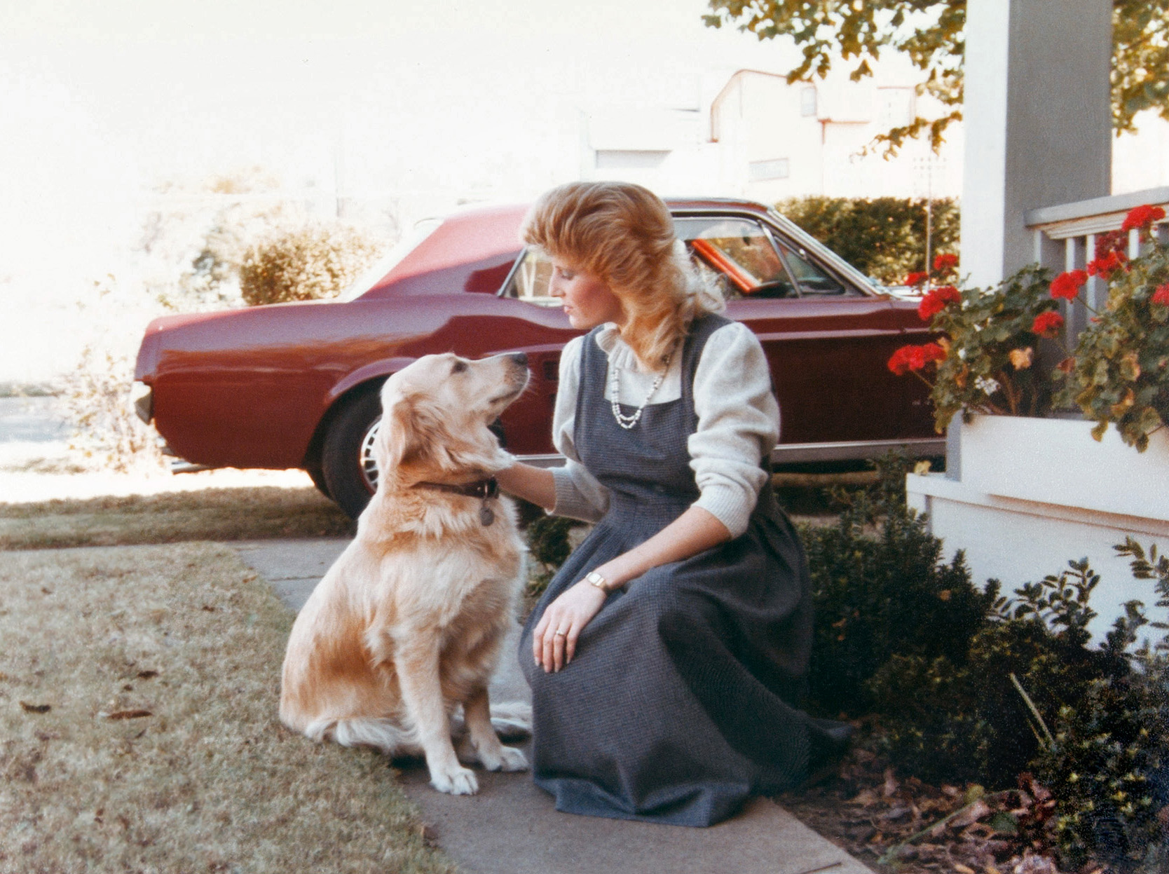 My mother outside her home in Dallas with our golden retriever Nikki and my dad's 1967 Ford Mustang. View full size.