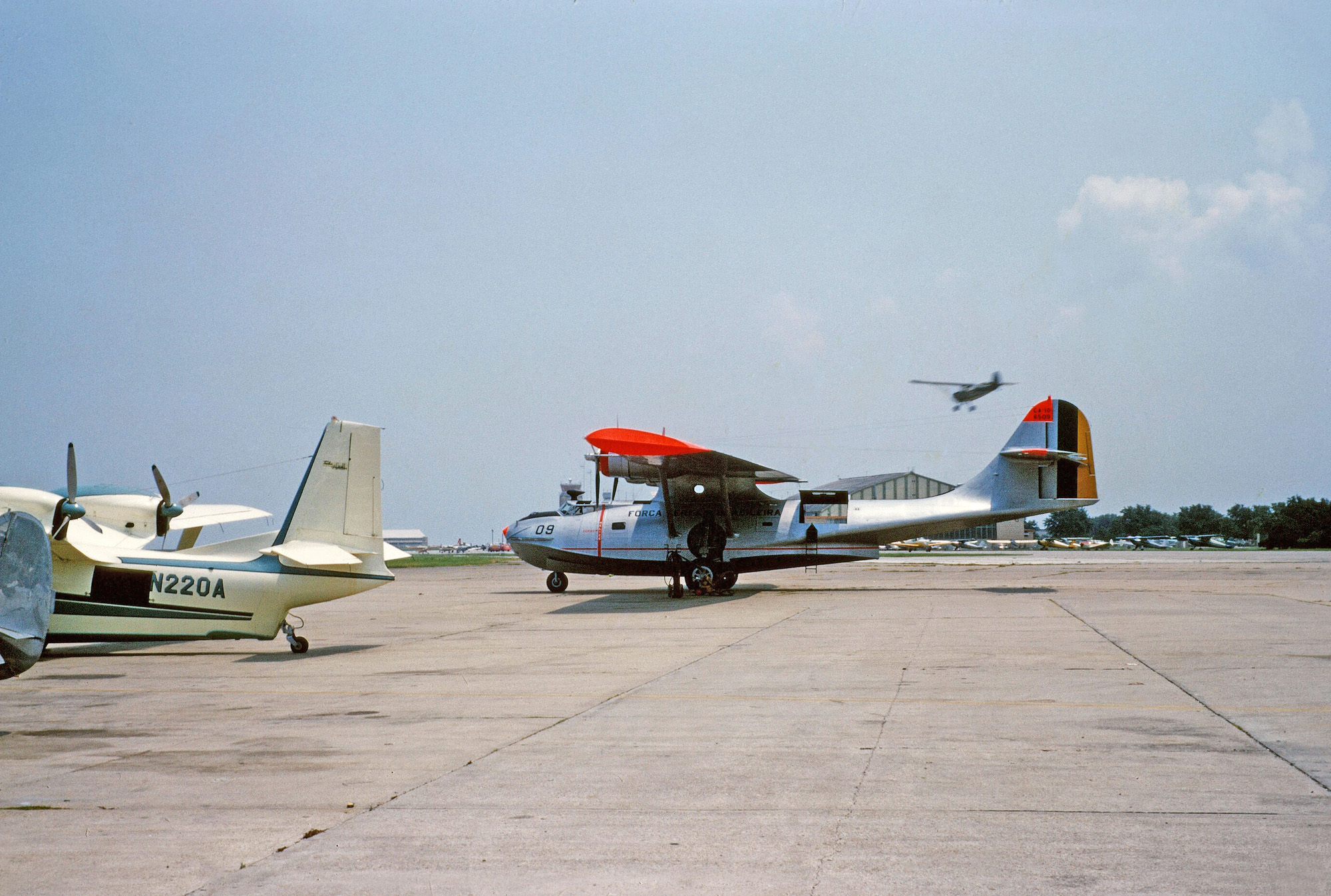 Taken at an unidentified airport where seaplanes were abundant in 1957 or so. I believe the pretty blue and white plane is a Piaggio P-136-L1, dwarfed by a Brazilian Consolidated PBY. View full size.