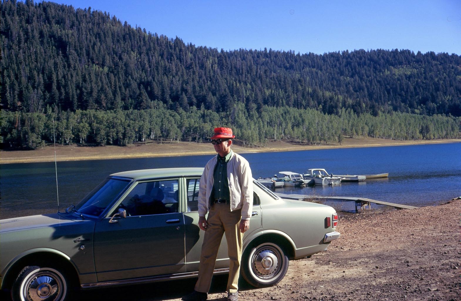 Southern Utah, and my father with our 1971 Toyota Corona. He taught me how to drive stick shift in this car, and several years later, I bought it and drove it for a few more years. 

Our cabin would be built near this lake. Good memories.

