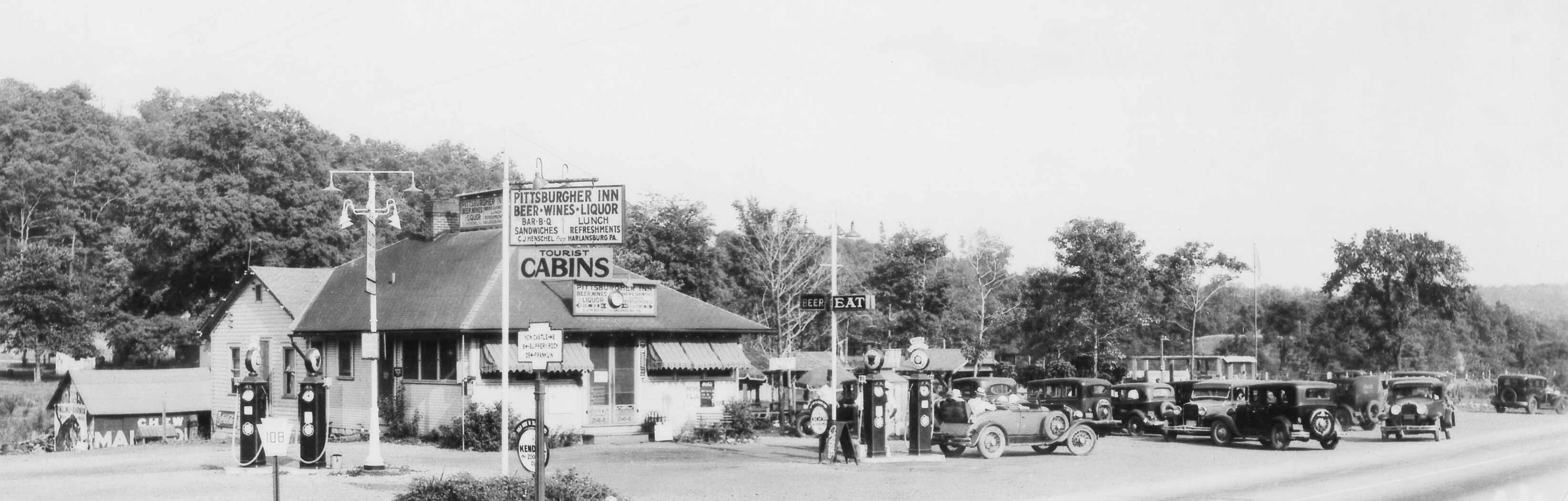 The Pittsburgher Inn was a Service Station, Restaurant and Saloon in the little town of Harlansburg Pennsylvania. Located at Route's 19 and 108 about 40 miles north of Pittsburgh. The picture looks to be late 30s or early 40s. Other amenities included a picnic area and cabins for rent. Before I-79 was built, Route 19 was the major road between Pittsburgh and Erie and was heavily traveled. View full size.