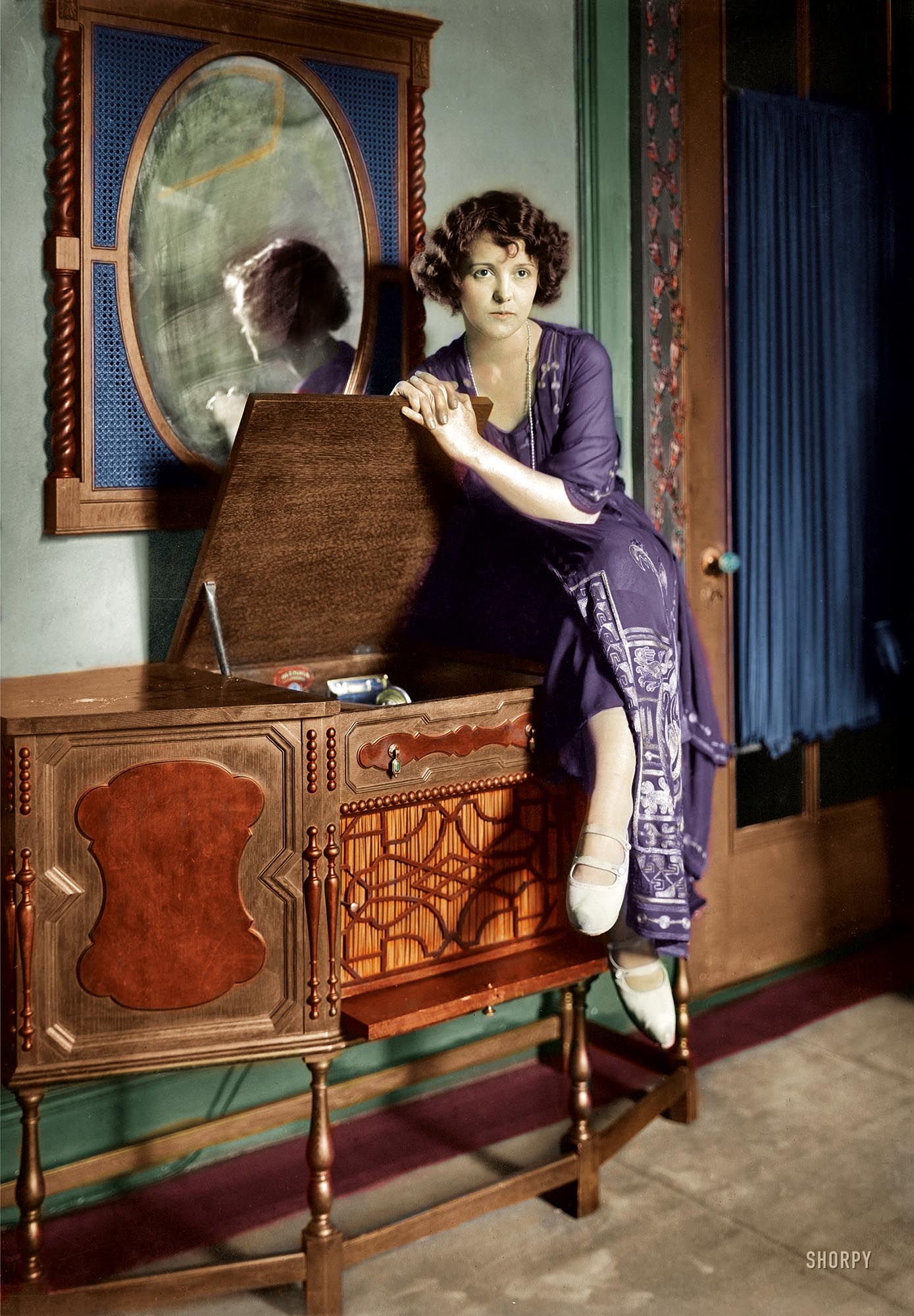 New York circa 1921. A lady and her phonograph. Colorized version of this Shorpy photo.