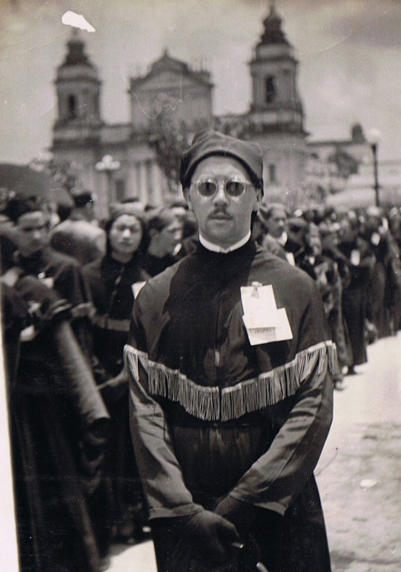 A religious procession participant. Guatemala City's Metropolitan Cathedral is in the background, circa 1947. View full size.
