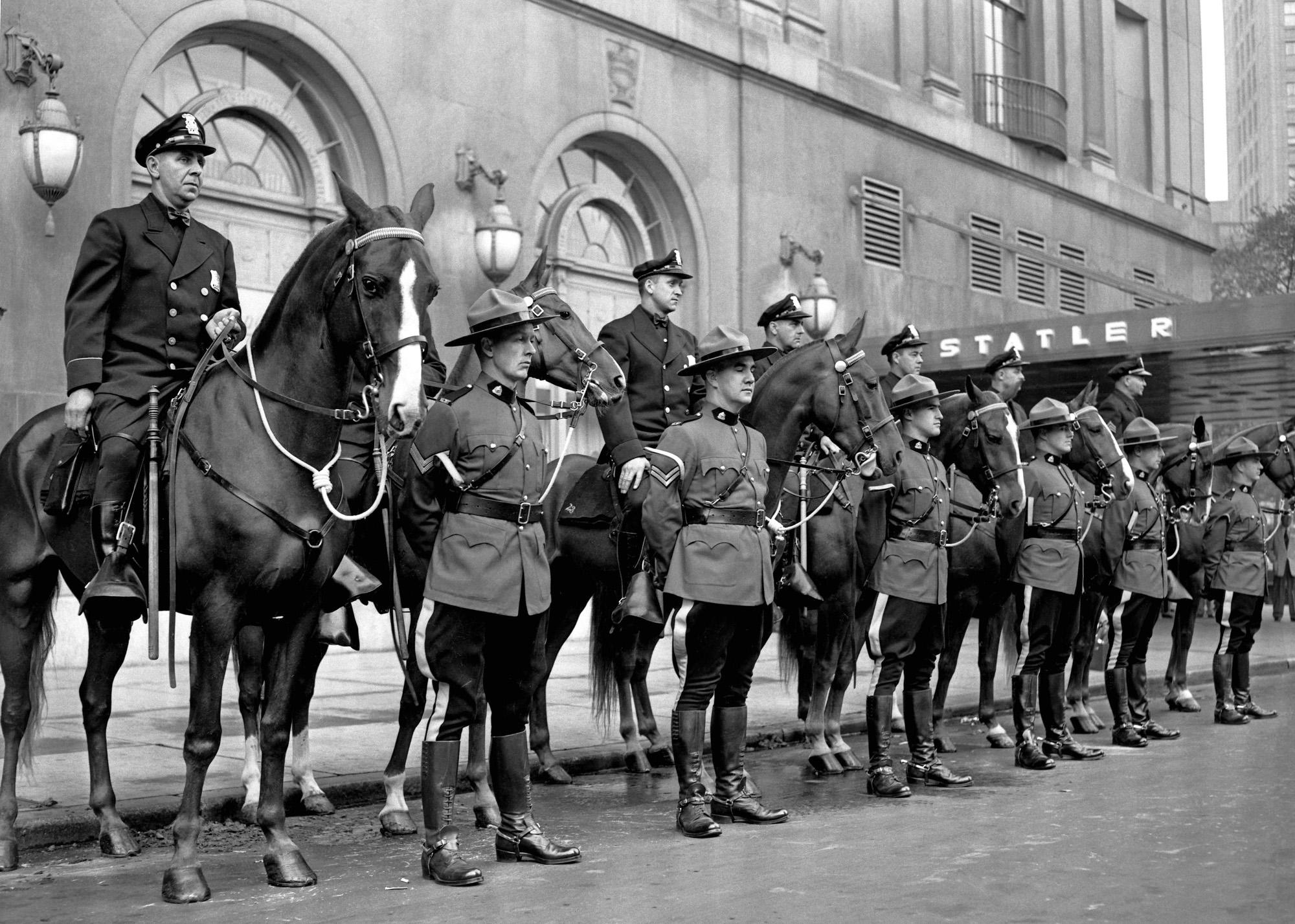 On July 24, 1951, the city of Detroit celebrated its 250th anniversary. To honor the occasion, a number of special events were held. This photo, shot by my grandfather, Howard McGraw of the Detroit News, depicts the Detroit police on horseback with the RCMP (Royal Canadian Mounted Police) standing in front, likely part of a parade.  Both groups stand in front of the old Statler hotel (since demolished)  located on Washington Blvd, near Grand Circus Park in downtown Detroit. View full size.