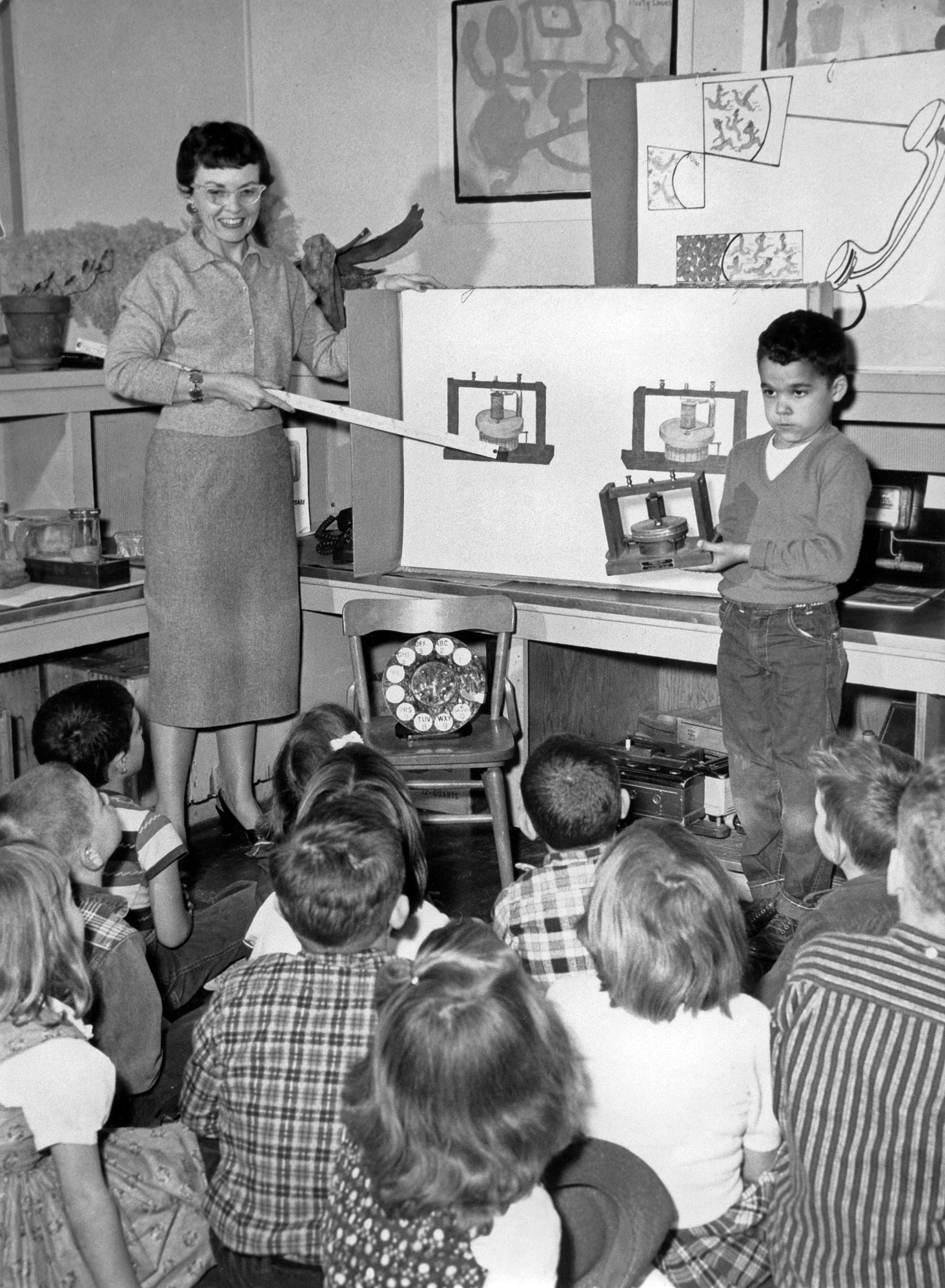 Kentfield, California 1958. Kindergarten class learning the finer points of the desktop telephone circa 1890s. Yours truly displaying said device. View full size.