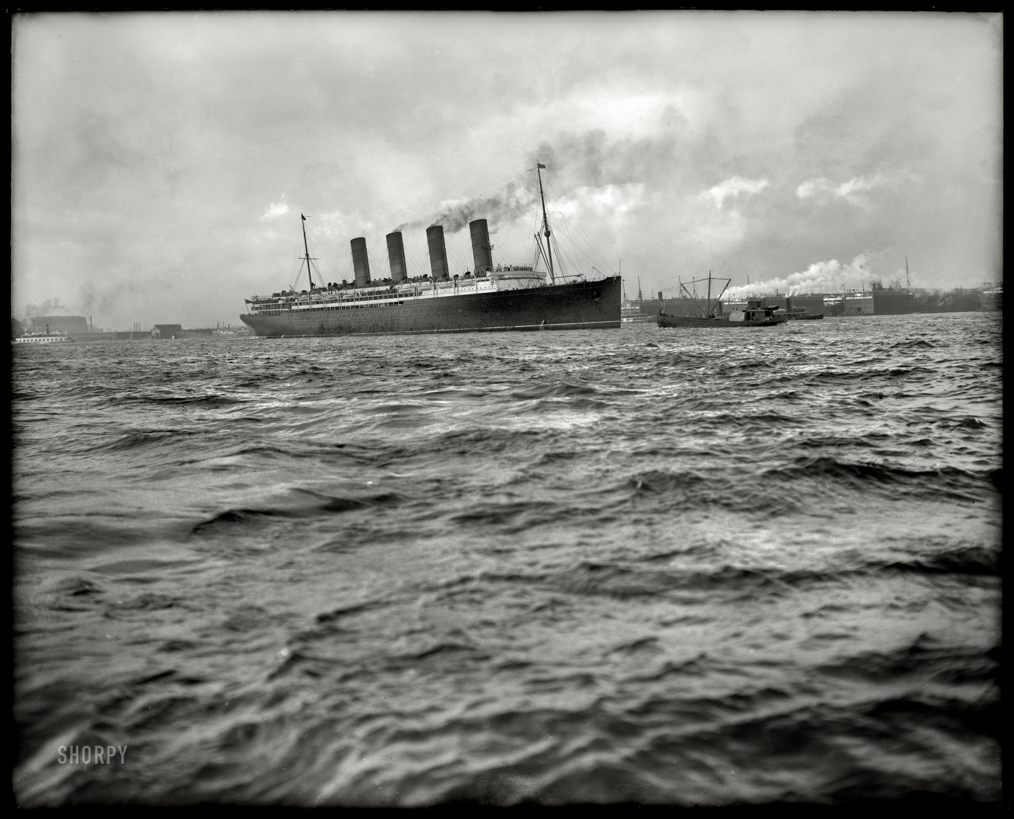 The Hudson River circa 1908. "RMS Lusitania passing Hoboken piers." The doomed Cunard ocean liner would be torpedoed by a German submarine in 1915 with a loss of 1,198 lives. Detroit Publishing glass negative. View full size.
