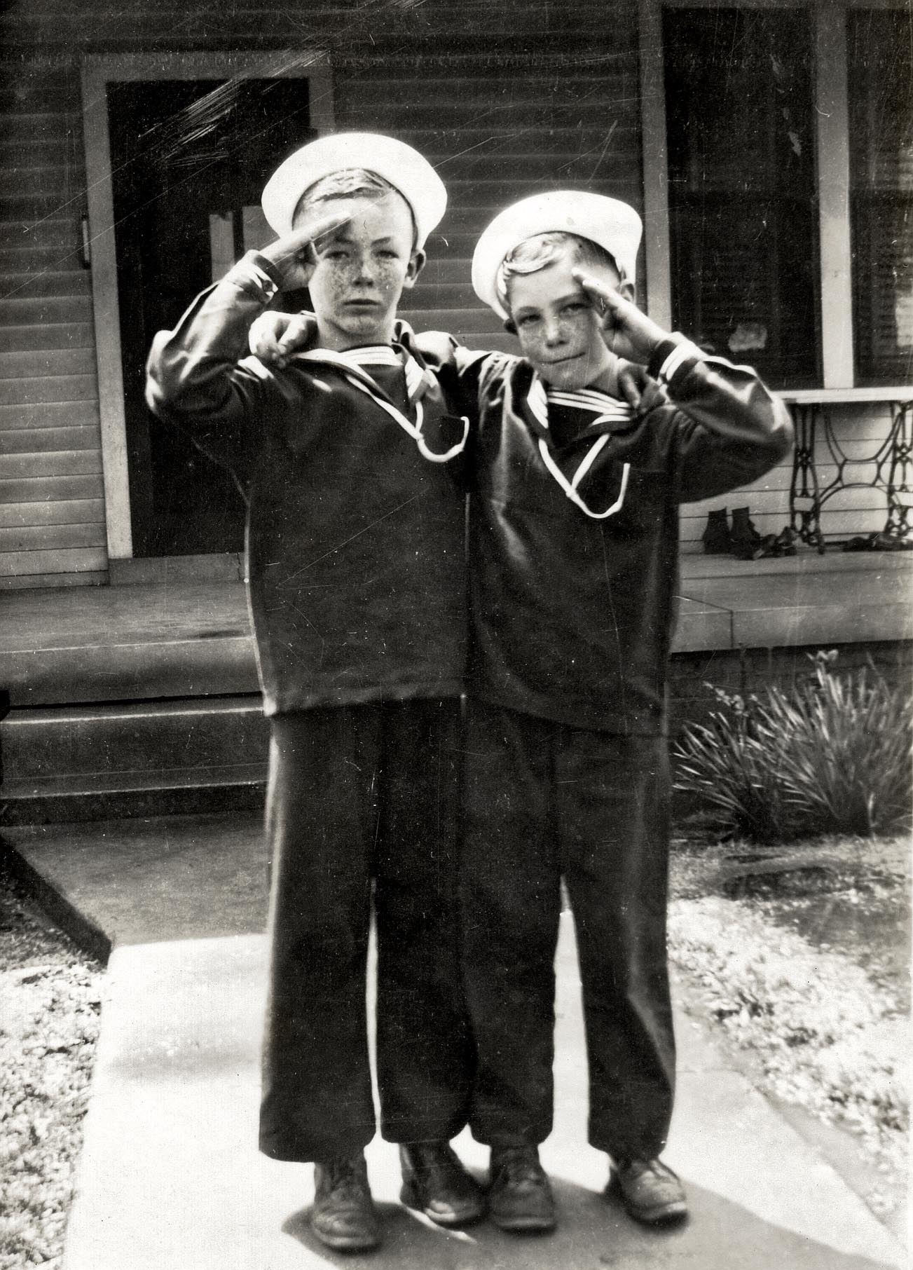 This is my father, John (on right), and his older brother, Rhea, in the summer of 1944.  My father is seven years old, and his brother is nine years old.  I believe this was taken in front of their grandmother's house in Whiteville (Hardeman County), Tennessee. View full size.