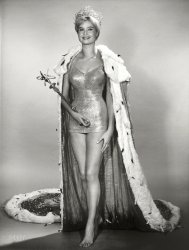 &nbsp; &nbsp; &nbsp; &nbsp; Reigning Queen -- Marlene Schmidt of Stuttgart, Germany, who is Miss Universe 1961, will yield the traditional crown and sceptre to her successor on the "Miss Universe Beauty Pageant" broadcast on the CBS Television Network Saturday, July 14 (10-11:30 PM, EDT).
July 1962. "Miss Universe 1961 Marlene Schmidt, full-length portrait, wearing crown, swimsuit, royal robe and holding scepter." UPI Telephoto. View full size.