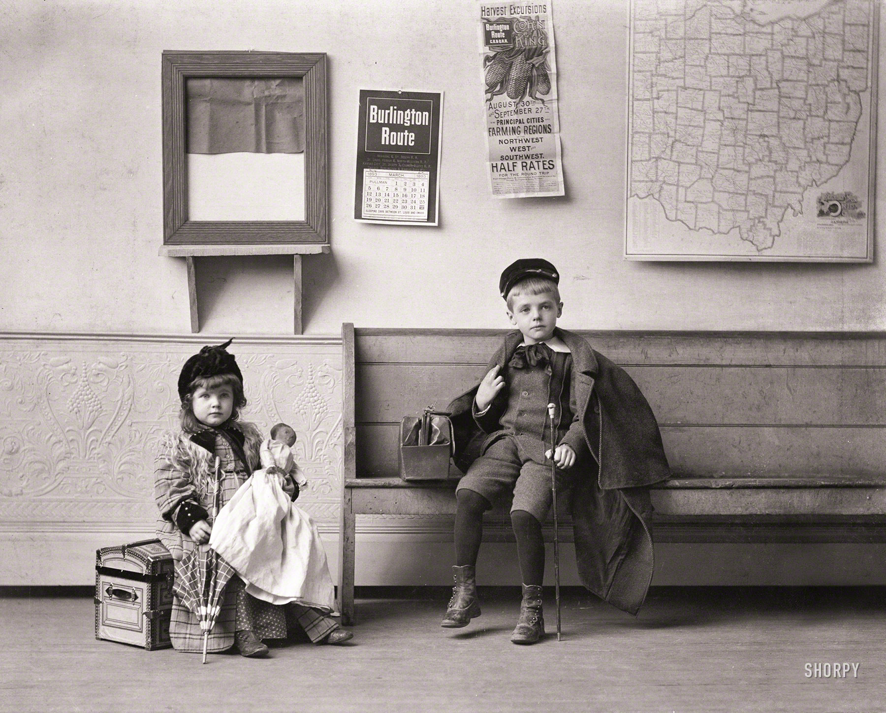 June 30, 1893. "Waiting for the train (girl and boy in railroad depot; map of Ohio on wall)." The photographer is credited as one Mrs. W.M. Gatch. View full size.