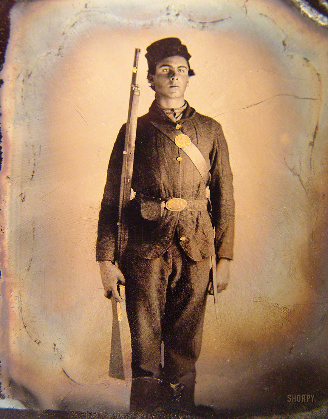 1861-65. "Soldier in Union uniform and cap box standing with musket and bayonet with scabbard." Sixth-plate tintype, hand-colored, removed from frame. Liljen&shy;quist Collection of Civil War Photographs, Library of Congress. View full size.
