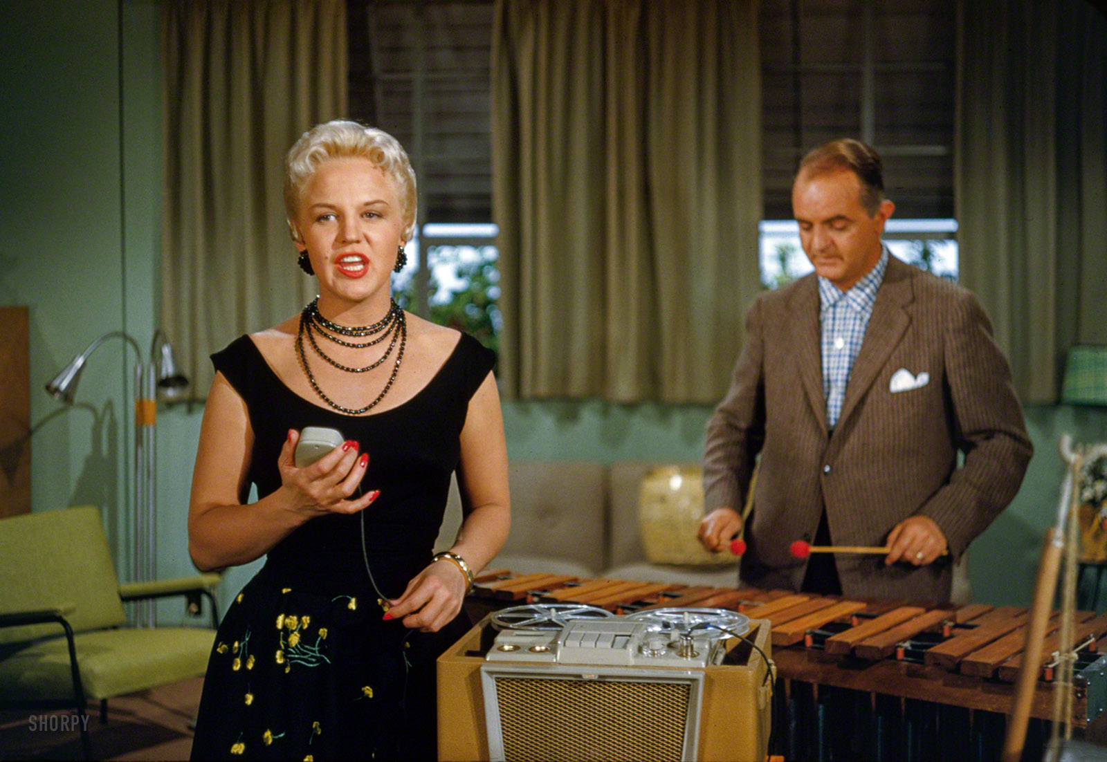 &nbsp; &nbsp; &nbsp; &nbsp; tterrace informs us: Filmed specifically for the Disneyland TV show episode "Cavalcade of Song," Feb. 16, 1955.
1955. "Peggy Lee singing into tape recorder accompanied by Sonny Burke. Soundtrack for Walt Disney CinemaScope cartoon feature Lady and the Tramp." 35mm Kodachrome by Robert Vose for Look magazine. View full size.