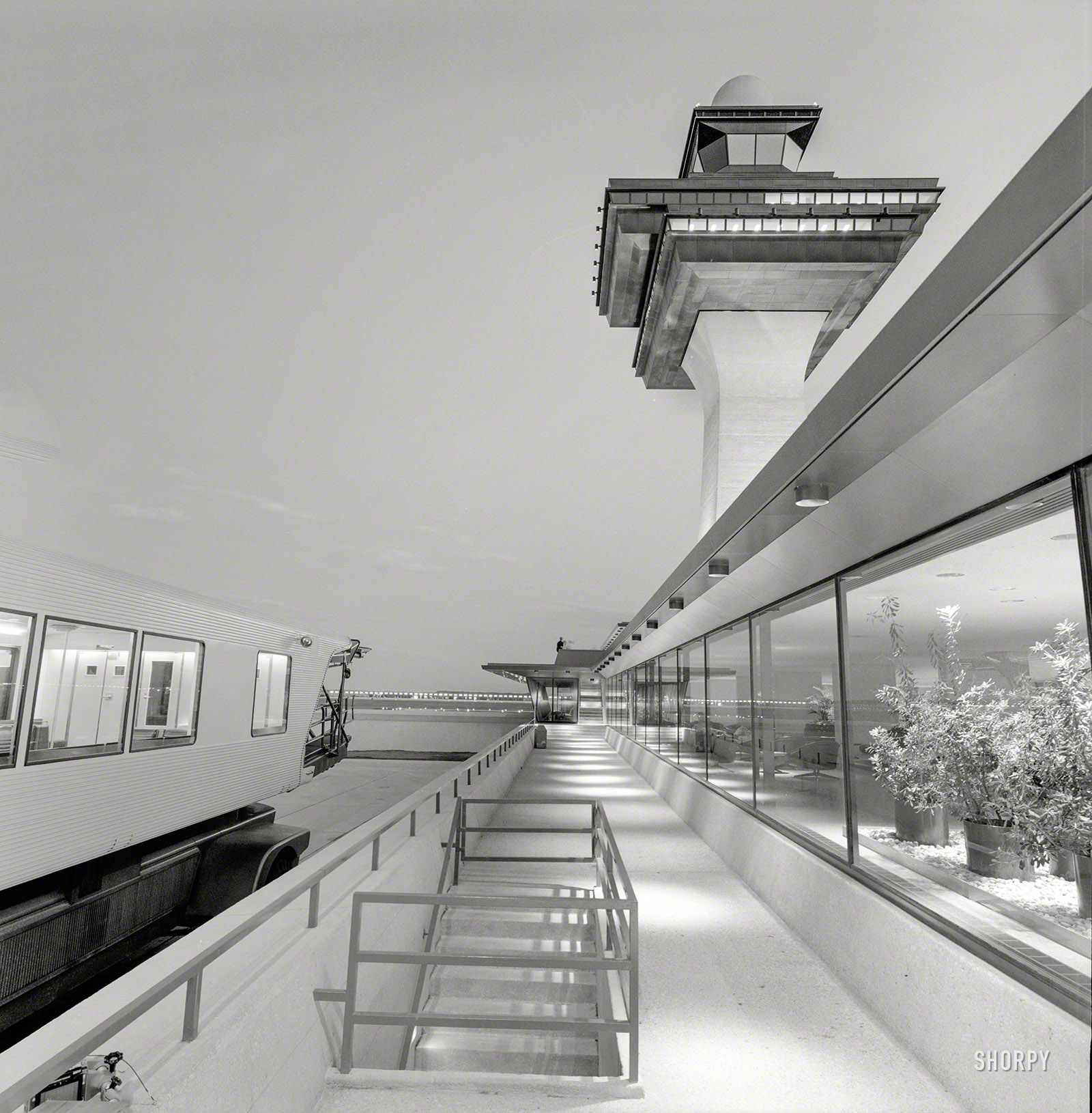 "Dulles International Airport, Chantilly, Virginia, 1958-63. Eero Saarinen, architect. Mobile lounge, control tower and terminal." All we need now is an airplane. Medium format negative by Balthazar Korab. View full size.