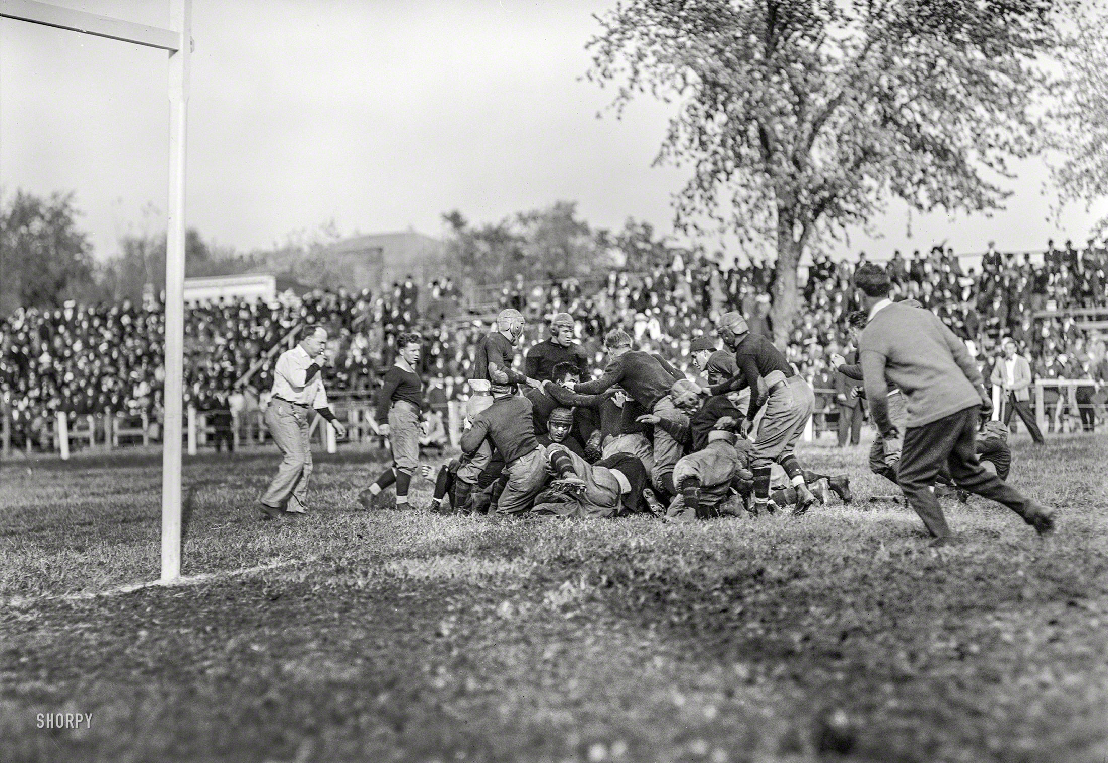 &nbsp; &nbsp; &nbsp; &nbsp; UPDATE: That's legendary athlete Jim Thorpe standing in the middle of the pile.
Washington, D.C., 1912. "Football -- Georgetown-Carlisle game; Glenn Warner." The College Football Hall of Famer who was coach of the Carlisle (Pa.) Indian Industrial School. Harris & Ewing Collection glass negative. View full size.