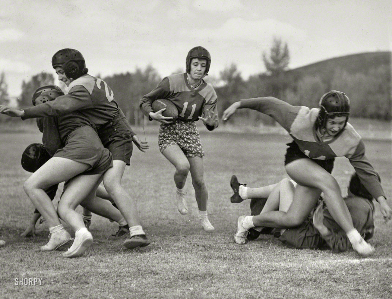 Oct. 14, 1939. "Hit that line, coed! Captain Alice Shanks, carrying football, running behind good interference as the young women from Western State College staged their annual Powder Bowl game on a mountain gridiron in Gunnison, Colorado." New York World-Telegram and Sun Newspaper Photo Collection. View full size.