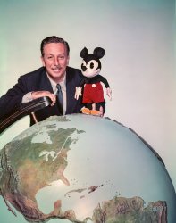 Los Angeles, 1954. "Walt Disney with Mickey Mouse stuffed toy astride large world globe." Color transparency from photos by Earl Theisen for the Look magazine assignment "Here's your first view of Disneyland," a year before it opened in Anaheim. View full size.