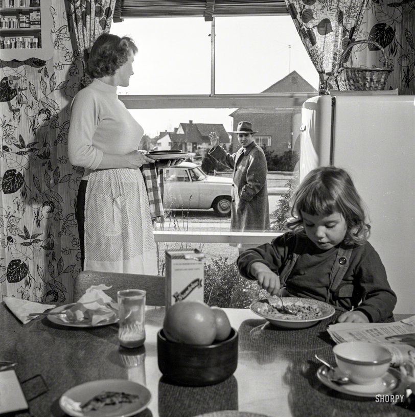 March 1955. "Men participating in family life. Includes women and children standing by window waving to men as they leave for work." Photo by Bob Lerner for the Look magazine assignment "Male Behavior." View full size.
