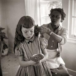 February 1956. "Domestic worker fixing girl's hair." From photos by Bern Keating for the Look magazine article "The South vs. the Supreme Court: What Is a South&shy;erner?" Library of Congress Prints and Photographs Collection. View full size.