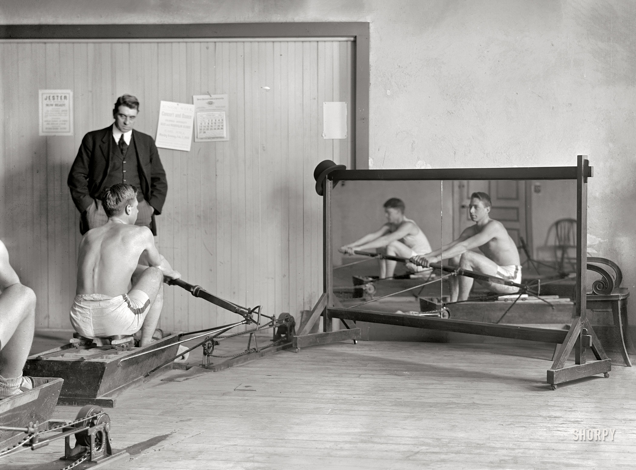 February 1910. New York. "Columbia rowing team in mock shells training in crew house with coach Jim Rice." 5x7 inch glass negative, Bain News Service. View full size.