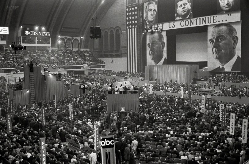 August 24, 1964. Atlantic City, New Jersey. "View of delegates and stage with large pictures of John F. Kennedy, Harry Truman, Franklin D. Roosevelt and Lyndon B. Johnson with the slogan 'Let Us Continue,' at the 1964 Democratic National Convention." 35mm acetate negative by Warren K. Leffler for U.S. News &amp; World Report. View full size.

