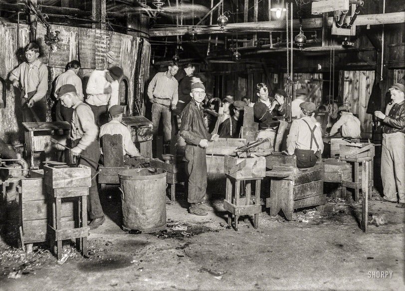 November 1909. "Night scene in Cumberland Glass Works, Bridgeton, N.J." Mak&shy;ing bottles one at a time. Glass negative by Lewis Wickes Hine. View full size.
